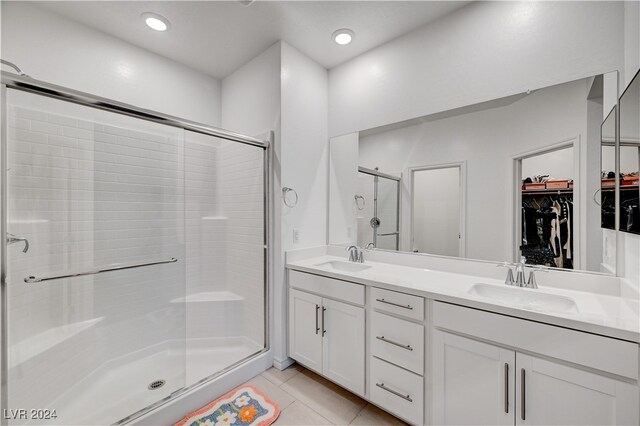 bathroom with vanity, a shower with door, and tile patterned floors