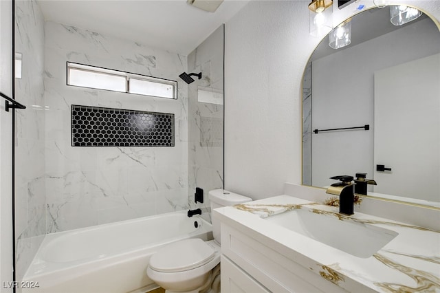 full bathroom with tiled shower / bath, toilet, and vanity