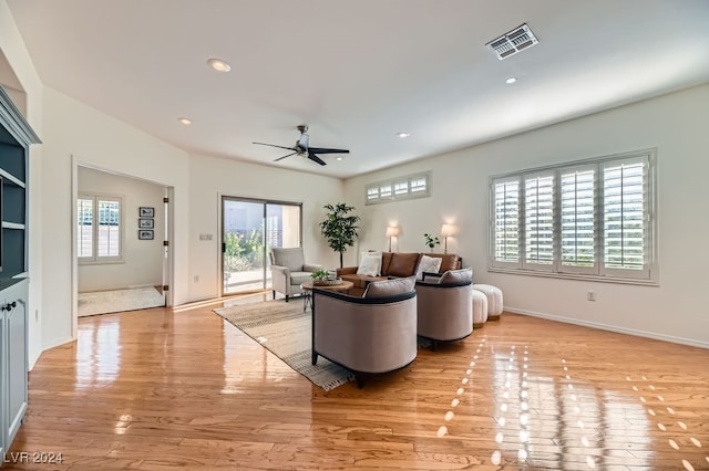 living room with ceiling fan and light hardwood / wood-style flooring