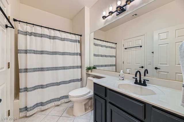 bathroom featuring toilet, walk in shower, vanity, and tile patterned floors