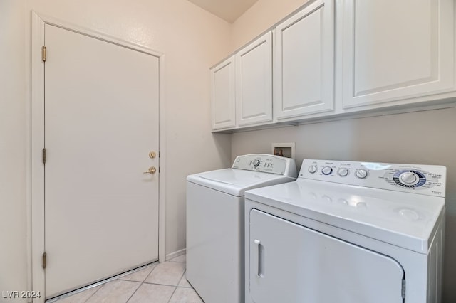 laundry room with cabinets, independent washer and dryer, and light tile patterned floors