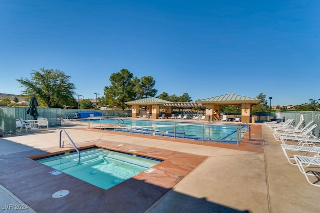 view of pool with a community hot tub, a gazebo, and a patio area