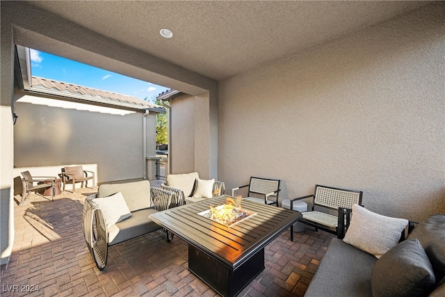 view of patio featuring an outdoor living space with a fire pit