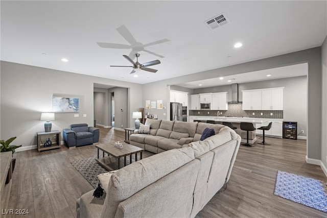 living room with hardwood / wood-style flooring and ceiling fan