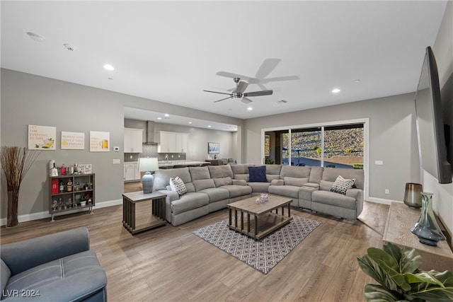 living room with ceiling fan and light hardwood / wood-style floors