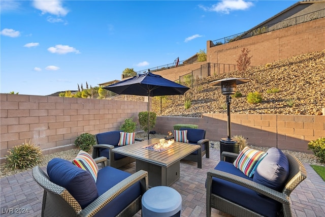 view of patio / terrace featuring an outdoor living space with a fire pit