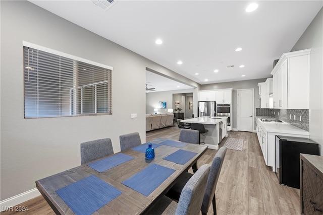 dining space featuring light wood-type flooring and ceiling fan