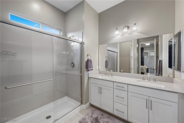 bathroom with a shower with door and vanity