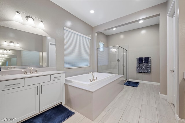 bathroom featuring vanity and shower with separate bathtub