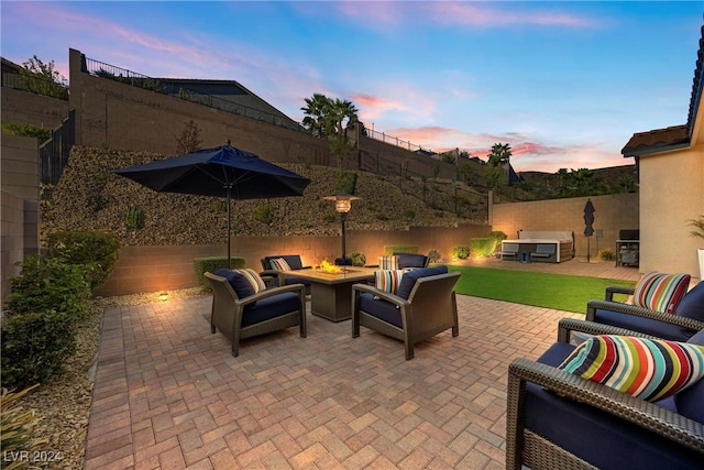 patio terrace at dusk featuring an outdoor hangout area