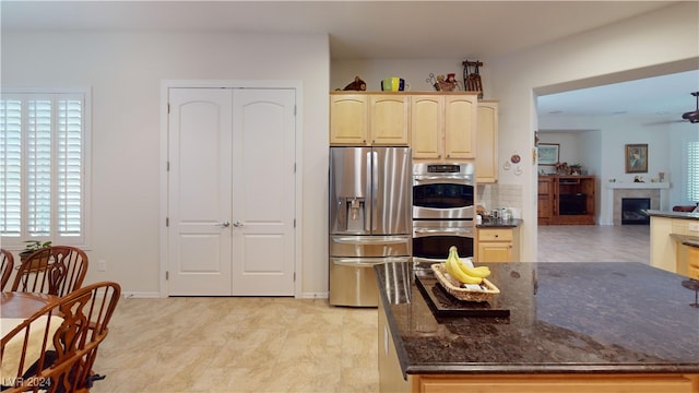 kitchen featuring dark stone countertops, appliances with stainless steel finishes, and tasteful backsplash