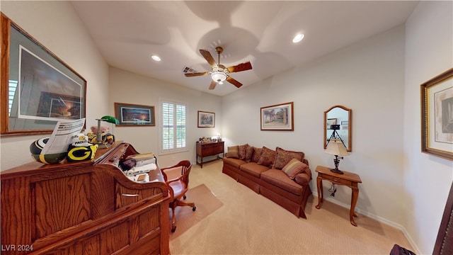 carpeted living room featuring ceiling fan