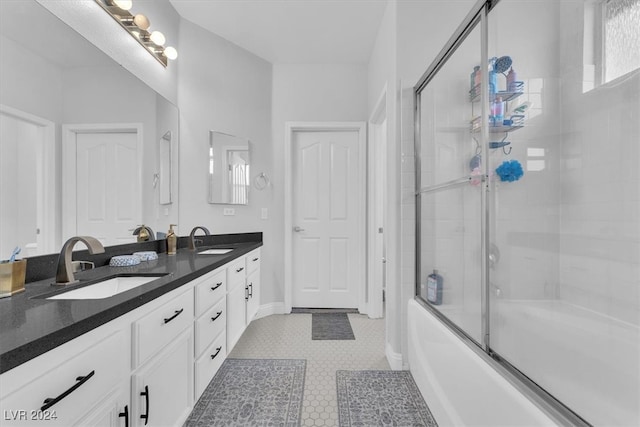 bathroom with enclosed tub / shower combo, vanity, and tile patterned floors