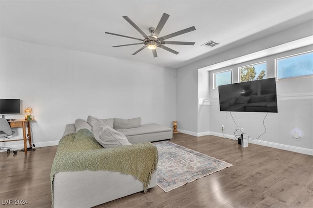 living room with wood-type flooring and ceiling fan