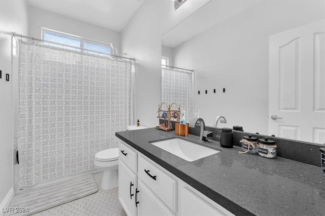 bathroom featuring tile patterned flooring, vanity, and toilet