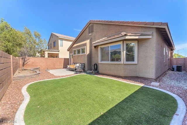 back of house with a patio, central AC, and a yard