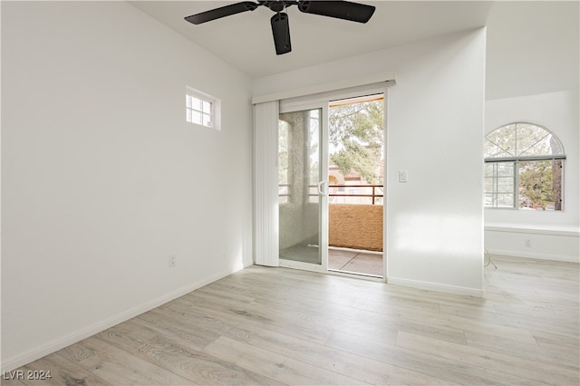 spare room with a wealth of natural light, ceiling fan, and light hardwood / wood-style flooring