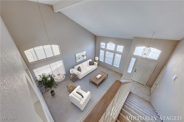 living room featuring high vaulted ceiling and a healthy amount of sunlight