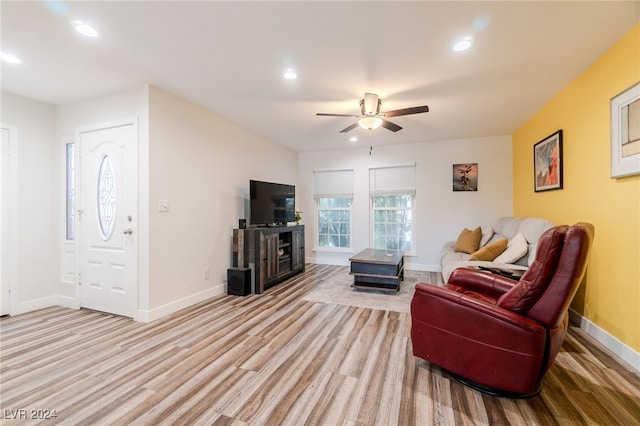 living room featuring ceiling fan and light hardwood / wood-style flooring