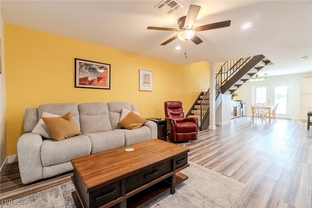 living room with ceiling fan and wood-type flooring