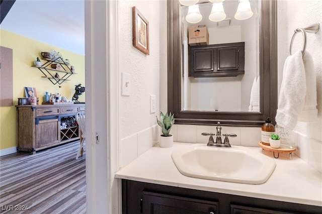 bathroom with vanity and hardwood / wood-style floors