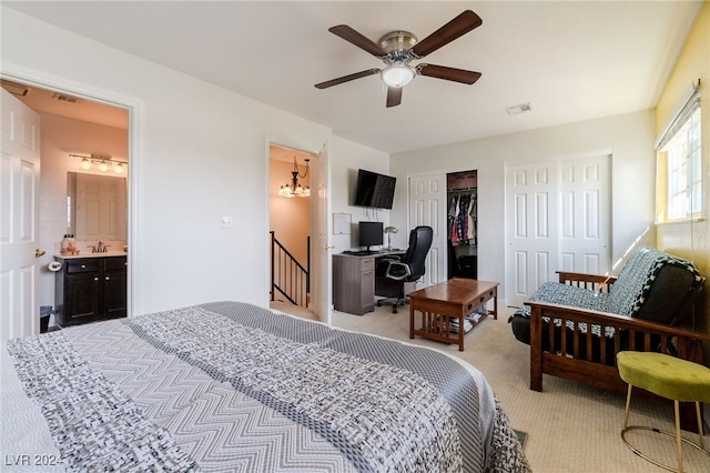 carpeted bedroom featuring sink, connected bathroom, ceiling fan, and a closet