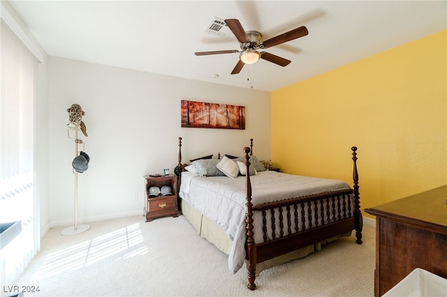 carpeted bedroom with ceiling fan and multiple windows