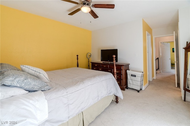 bedroom featuring light carpet and ceiling fan