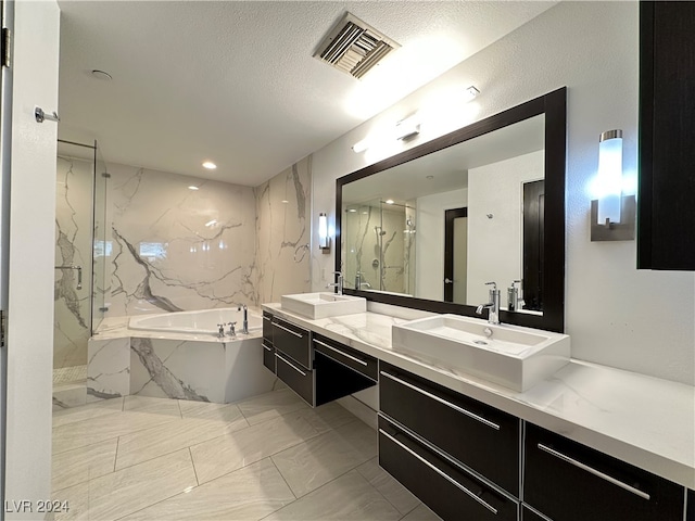 bathroom featuring vanity, plus walk in shower, and a textured ceiling