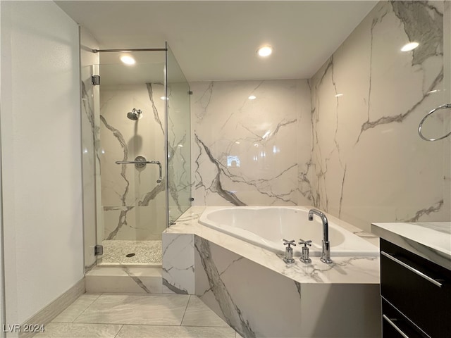 bathroom with vanity and shower with separate bathtub