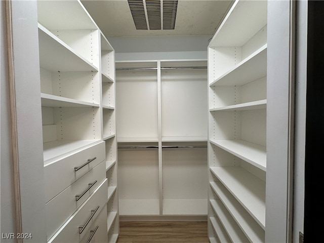 spacious closet with hardwood / wood-style floors