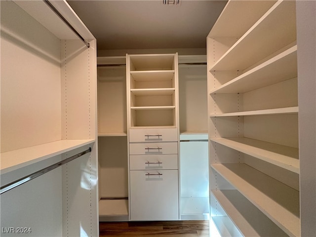 walk in closet featuring dark wood-type flooring