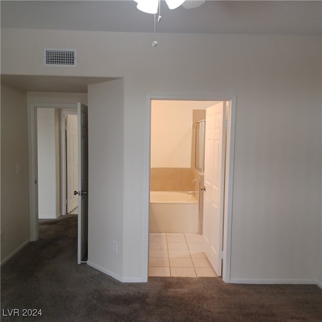 unfurnished bedroom featuring carpet, ceiling fan, and connected bathroom