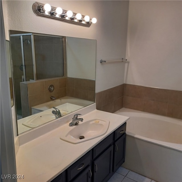 bathroom with vanity, tile patterned floors, and a washtub