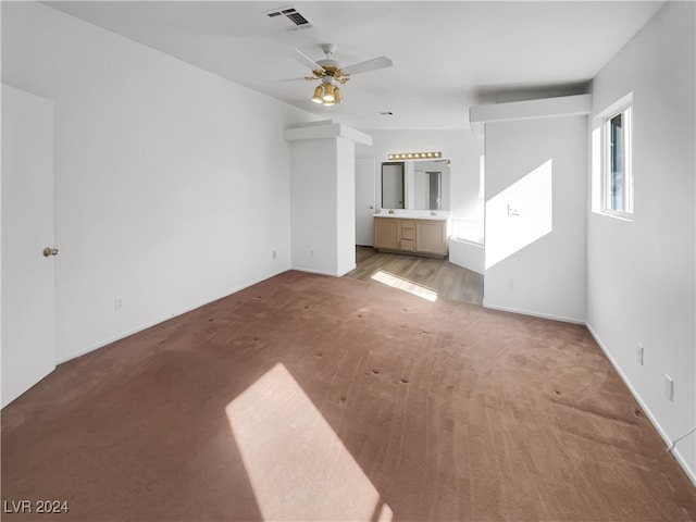 unfurnished living room with ceiling fan and carpet floors