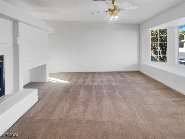 unfurnished living room with ceiling fan and light colored carpet