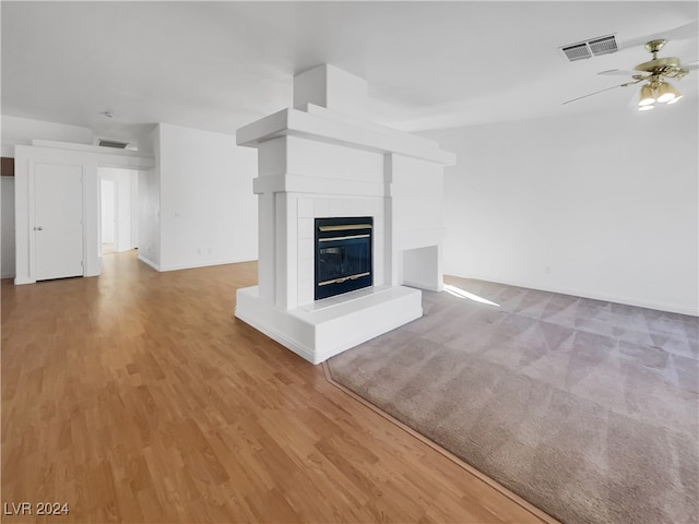 unfurnished living room with ceiling fan and light wood-type flooring