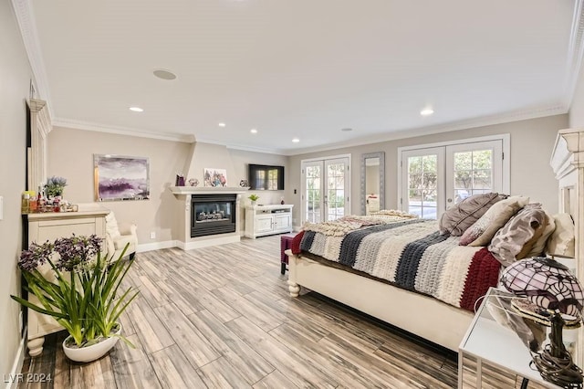 bedroom with ornamental molding, french doors, light wood-type flooring, and access to exterior