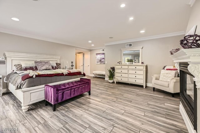 bedroom featuring light wood-type flooring and crown molding