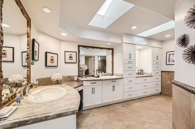 bathroom featuring a skylight and vanity