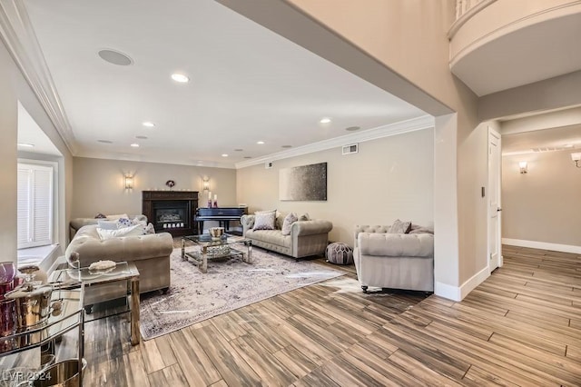 living room with light wood-type flooring and crown molding