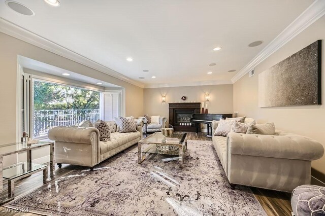 living room featuring ornamental molding and wood-type flooring