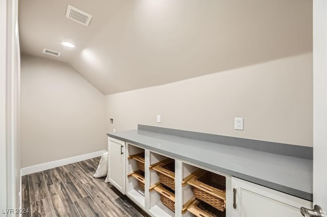 unfurnished office with lofted ceiling and wood-type flooring