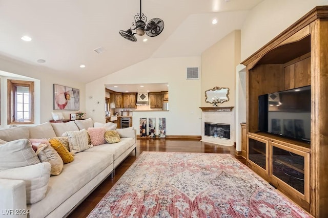 living room featuring dark hardwood / wood-style flooring and vaulted ceiling