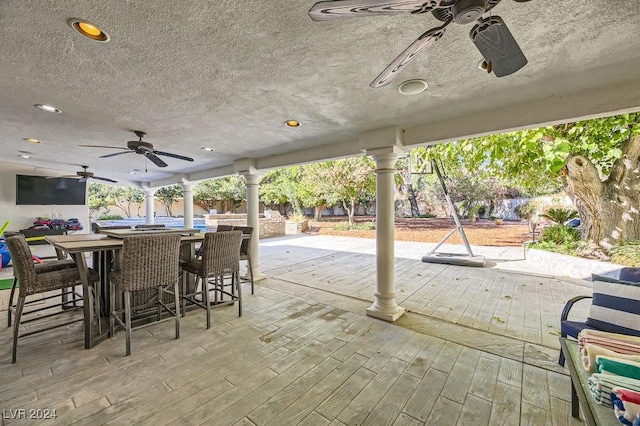 view of patio / terrace with ceiling fan and exterior bar