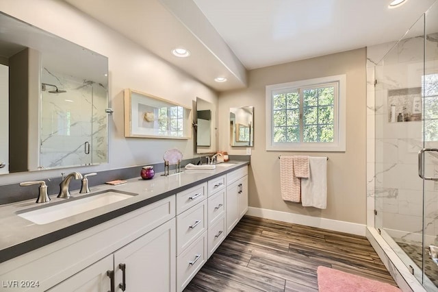 bathroom with vanity, hardwood / wood-style floors, and a shower with shower door