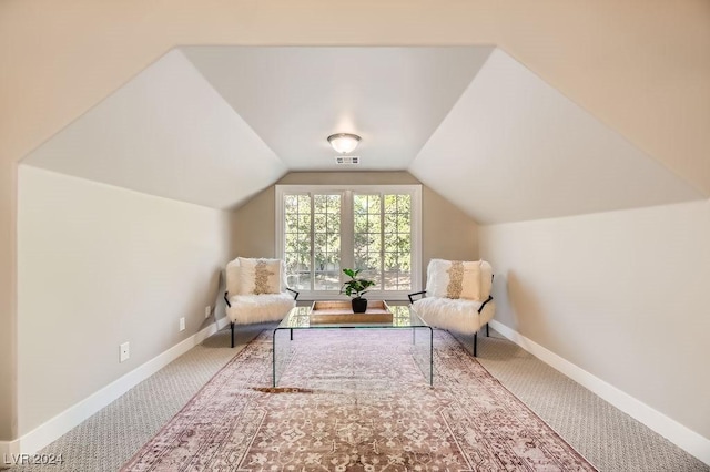 sitting room featuring lofted ceiling and carpet flooring