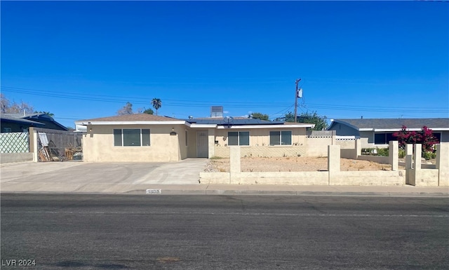 ranch-style house with solar panels