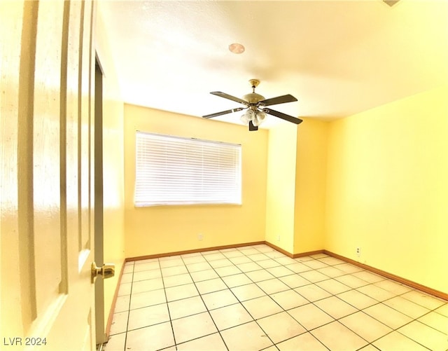 spare room featuring ceiling fan and light tile patterned floors