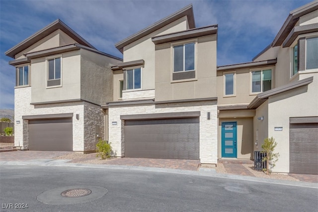 townhome / multi-family property featuring a garage